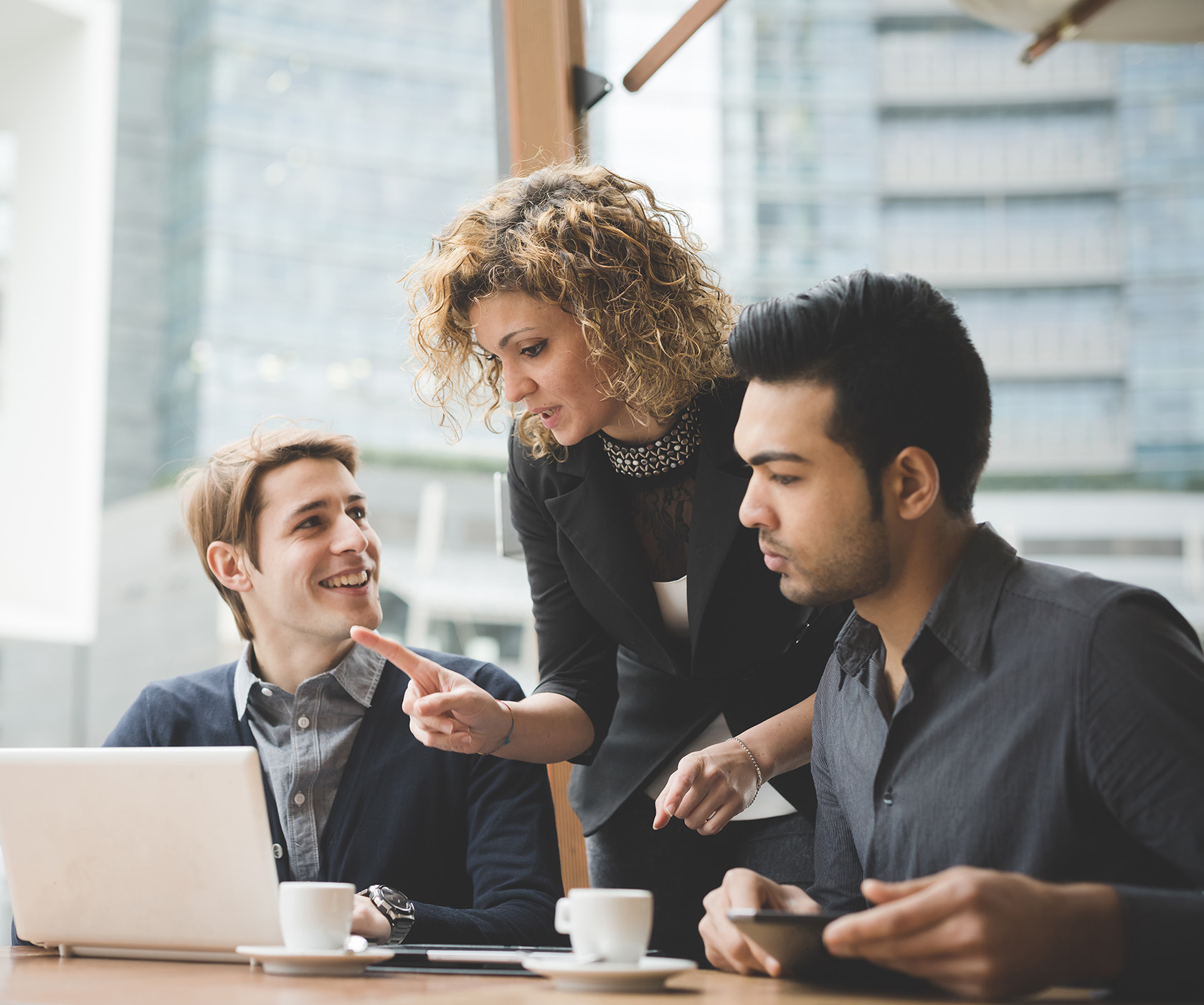 Business people working connected with technological devices like tablet and laptop, talking together